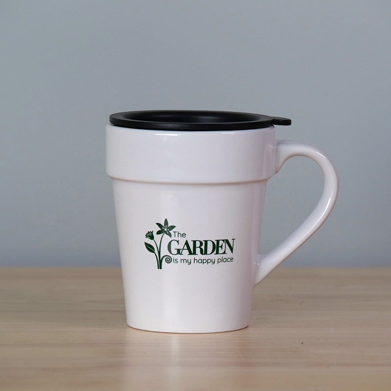 White mug with text saying The garden is my happy place